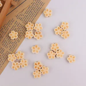 Close-up of wooden five-petal flower beads for DIY jewelry and handmade crafting