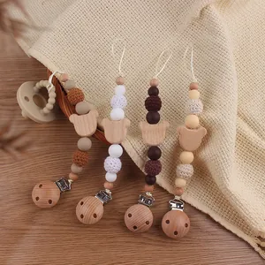 Macro detail of beech wood bear clips with crochet beads and food-grade silicone pearls