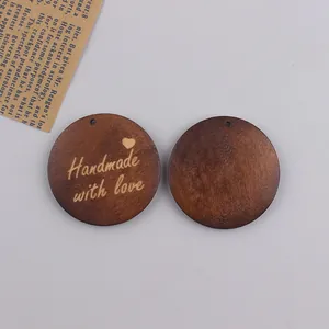 Detail of round walnut wood tag engraved with 'Handmade with love' for DIY crafting
