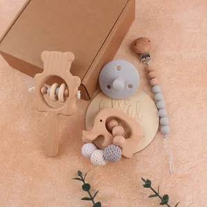 Baby gift set with bear beech wood rattle, pacifier clip and silicone nipple in a box