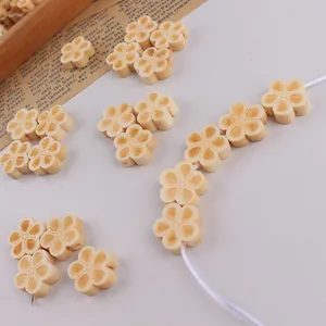 Detailed macro view of cream wooden flower beads for DIY handmade jewelry crafting