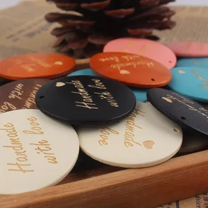 Macro shot of colorful wooden tags with Handmade with Love gold engraving detail
