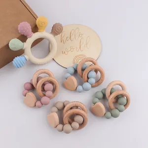 Macro shot of silicone and beech wood baby teethers with soft pastel colors