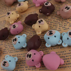 Close-up of cartoon bear silicone beads for DIY jewelry making on vintage paper