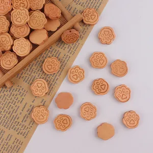 Detailed macro shot of natural wooden cat paw beads with center holes for DIY crafts