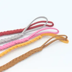 Detail of braided faux leather pacifier clips in red, grey, pink, yellow, and brown colors