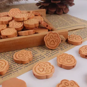 Natural cat paw wooden beads for DIY handmade jewelry crafting on vintage background