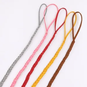Detail of multi-color braided leather pacifier clips in grey, pink, red, yellow and brown