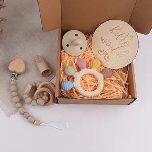 Silicone and wood newborn gift set including rattles, pacifier, and teether items