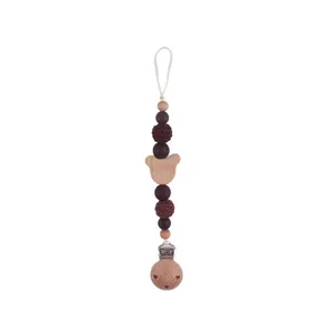 Beech wood bear-shaped baby pacifier clip with silicone and crochet beads on white base