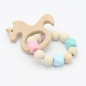 Detail of wooden unicorn teething ring and food-grade silicone beads for babies