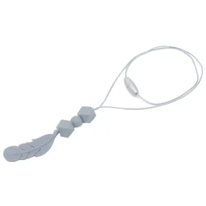 Detail of light gray feather silicone teething necklace with geometric beads and safety clasp