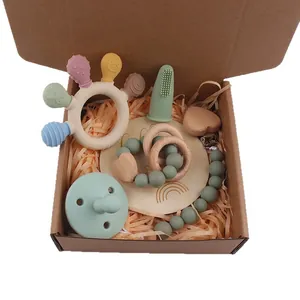 Silicone newborn teething gift set with wooden pacifier clip in a cardboard gift box