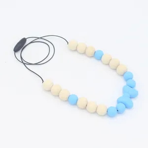 Fermoir de sécurité et détail du collier de dentition avec nœud bleu et perles en bois