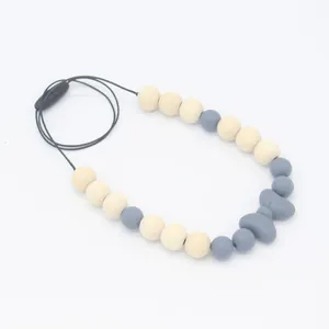 Collier de dentition pour bébé avec nœud en silicone gris et perles en bois naturel