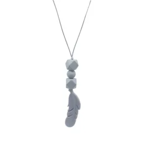 Detail of gray silicone feather teething pendant with geometric beads for babies