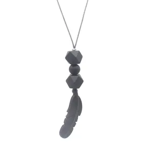Close-up of food-grade silicone feather teething necklace with matte black beads