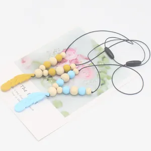 Collier de Dentition en Silicone Forme de Plume Avec Perles en Bois Sans BPA Jouet de Soulagement pour Nourrissons et Bambins