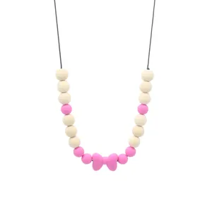 Collier de dentition bébé avec perles en bois et pendentif nœud en silicone rose