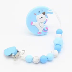 Close-up of silicone baby pacifier clip with blue moon, unicorn and marble beads