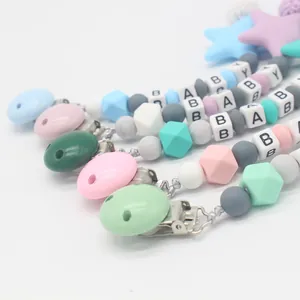 Silicone pacifier clip with colorful beads and BABY letter beads on white background