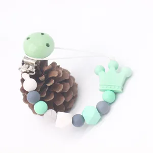 Macro shot of silicone pacifier clip with mint crown teether and marble beads