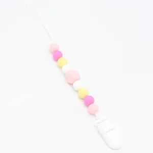 Detailed view of colorful silicone beads pacifier clip with white plastic safety buckle