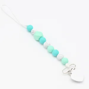Detail of baby pacifier clip with heart metal clasp and mint green silicone beads