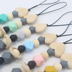Assorted silicone and wood bead pacifier clips featuring heart-shaped wooden accents