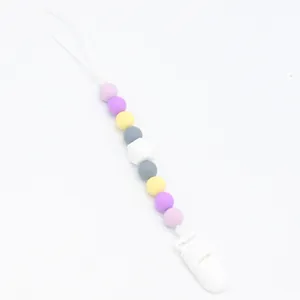 Close-up of silicone pacifier clip with colorful beads and secure plastic clasp attachment