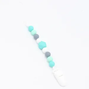 Detail of silicone baby pacifier clip with mint green and grey hexagonal beads