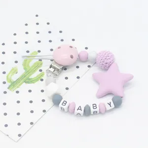 Close-up of silicone pacifier clip with star pendant and BABY letter beads