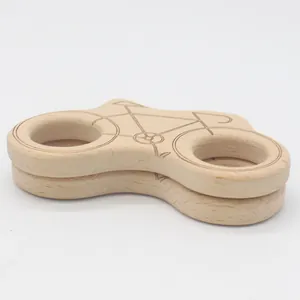 Detailed close-up of a bicycle-shaped beech wood baby teether with smooth edges