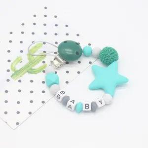 Macro shot of silicone beads and wooden clip on a pacifier chain with BABY letter beads