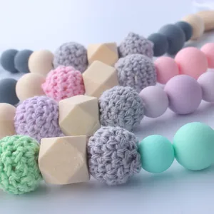 Macro detail of baby teething set with beech wood beads and colorful silicone spheres