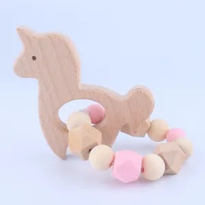 Detail of baby beech wood animal teether with pink silicone beads for infant sensory play