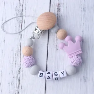 Silicone pacifier clip with purple crown, wooden beads, and BABY letter charms