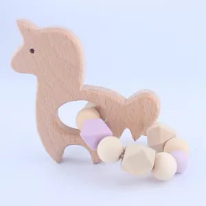Detail view of alpaca shaped beech wood baby teether with purple silicone beaded ring