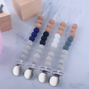 Set of 4 DIY silicone and beech wood baby pacifier clips in assorted neutral colors