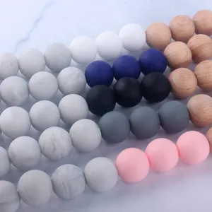 Close-up of silicone and natural beech wood beads in various colors for DIY pacifier clips