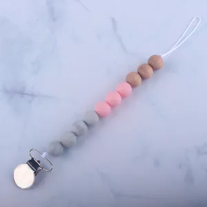 Detail of baby pacifier clip with marble grey, pink silicone beads and beech wood beads