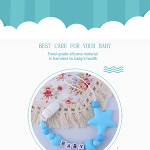Detail of baby pacifier clip with blue silicone beads and baby letter cubes