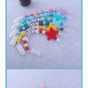 Detailed view of colorful silicone baby pacifier clips with BABY letter beads and stars