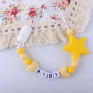 Detail of baby pacifier clip with yellow silicone beads, star pendant and baby letter beads