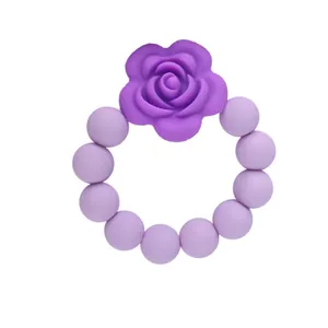 Massaggiagengive rosa in silicone con fiore viola scuro e perline in silicone