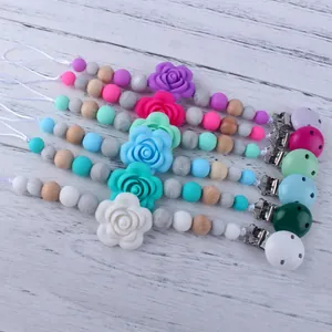 Silicone baby pacifier clips set with food grade beads and wooden accents in warm tones