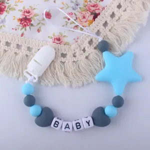 Detail of baby pacifier clip with silicone beads, star pendant and BABY letter cubes