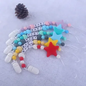 Silicone pacifier clip chain with colorful macaron beads for baby on white plush background