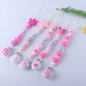 Detailed set of silicone pacifier clips with star, crown, and baby letter beads decoration