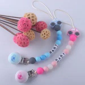 Silicone baby pacifier clips with star beads and car motifs in blue and pink colors
